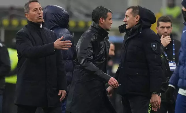 Inter Milan's head coach Cristian Chivu, center, leaves the pitch after receiving a red card during the Serie A soccer match between Inter Milan and Atalanta in Milan, Italy, Saturday, March 14, 2026. (AP Photo/Antonio Calanni)