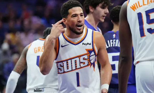 Phoenix Suns guard Devin Booker (1) talks with an official during the first half of an NBA basketball game against Sacramento Kings, Tuesday, March 3, 2026, in Sacramento, Calif. (AP Photo/Alan Greth)