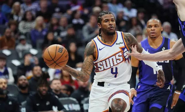 Phoenix Suns guard Jalen Green (4) passes the ball during the first half of an NBA basketball game against the Sacramento Kings, Tuesday, March 3, 2026, in Sacramento, Calif. (AP Photo/Alan Greth)