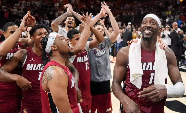 Miami Heat center Bam Adebayo, right, celebrates with teammates after he scored 83 points, the second-highest single game total in NBA history, in an NBA basketball game against the Washington Wizards, Tuesday, March 10, 2026, in Miami. (AP Photo/Rebecca Blackwell)