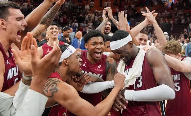 Miami Heat teammates celebrate center Bam Adebayo (13) after he scored 83 points, the second-highest single game total in NBA history, in an NBA basketball game against the Washington Wizards, Tuesday, March 10, 2026, in Miami. (AP Photo/Rebecca Blackwell)
