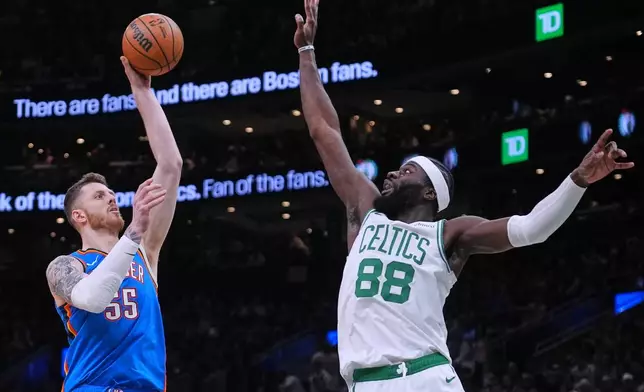Oklahoma City Thunder center Isaiah Hartenstein (55) takes a shot over Boston Celtics center Neemias Queta (88) during the first half of an NBA basketball game, Wednesday, March 25, 2026, in Boston. (AP Photo/Charles Krupa)