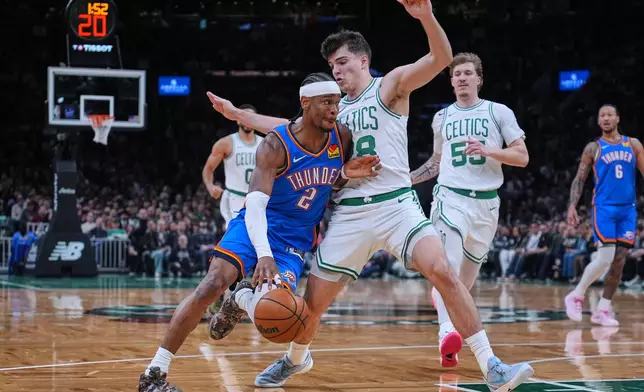 Oklahoma City Thunder guard Shai Gilgeous-Alexander (2) drives to the basket against Boston Celtics guard Hugo Gonzalez (28) during the first half of an NBA basketball game, Wednesday, March 25, 2026, in Boston. (AP Photo/Charles Krupa)