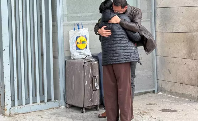 A man welcomes a woman who crossed from Iran to Turkey at the Kapikoy Border Gate in eastern Van province, Turkey, Thursday, March 5, 2026. (AP Photo/Serra Yedikardes)