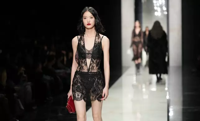 A model wears a creation from the Dolce &amp; Gabbana Fall/Winter 2026-2027 Women's collection, presented in Milan, Italy, Saturday, Feb. 28, 2026. (AP Photo/Antonio Calanni)