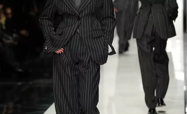 A model wears a creation from the Dolce &amp; Gabbana Fall/Winter 2026-2027 Women's collection, presented in Milan, Italy, Saturday, Feb. 28, 2026. (AP Photo/Antonio Calanni)