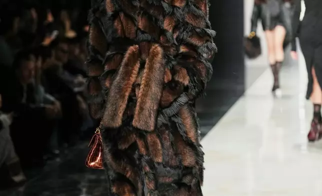 A model wears a creation from the Dolce &amp; Gabbana Fall/Winter 2026-2027 Women's collection, presented in Milan, Italy, Saturday, Feb. 28, 2026. (AP Photo/Antonio Calanni)