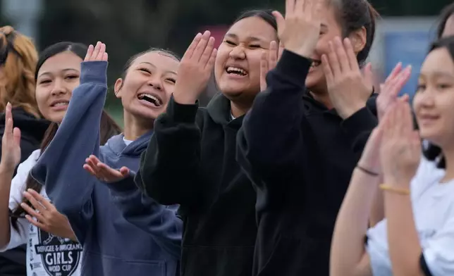 Members of KYNAW FC team dance during an introduction ceremony before a soccer tournament for immigrant and refugee girls on Sunday, March 29, 2026, in Portland, Ore. (AP Photo/Jenny Kane)