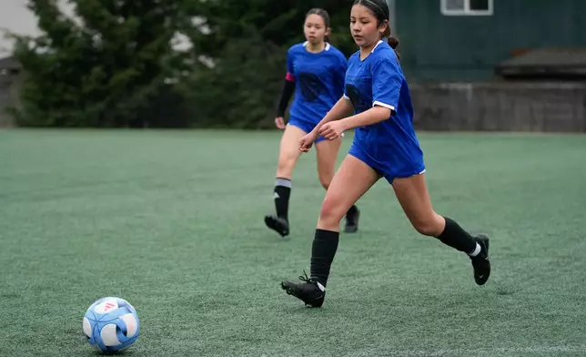 Valeria Hernandez, right, runs during a soccer tournament for immigrant and refugee girls on Sunday, March 29, 2026, in Portland, Ore. (AP Photo/Jenny Kane)