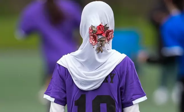 Suraya Abdull plays in a soccer tournament for immigrant and refugee girls on Sunday, March 29, 2026, in Portland, Ore. (AP Photo/Jenny Kane)