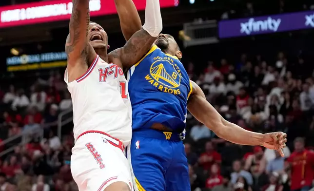 Houston Rockets forward Jabari Smith Jr., left, shoots as Golden State Warriors guard De'anthony Melton defends during the first half of an NBA basketball game Thursday, March 5, 2026, in Houston. (AP Photo/Eric Christian Smith)