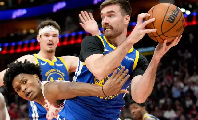Golden State Warriors guard Pat Spencer, right, looks to pass as Houston Rockets guard Amen Thompson defends during the first half of an NBA basketball game Thursday, March 5, 2026, in Houston. (AP Photo/Eric Christian Smith)