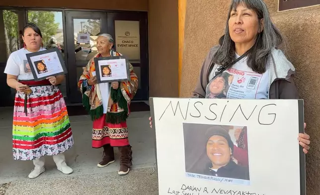 Lynette Pino, right, holds a sign showing her son, Darian Nevayaktewa, who went missing in 2008, while she, other family members and supporters mark Missing and Murdered Indigenous Persons Awareness Day during an event in Albuquerque, New Mexico, on Monday, May 5, 2025. (AP Photo/Susan Montoya Bryan)