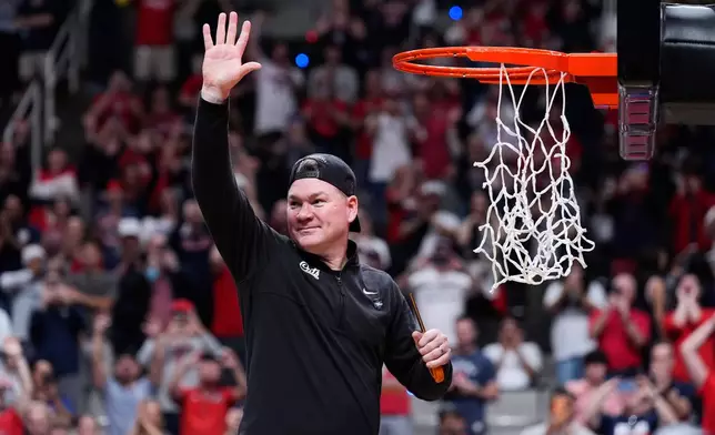 Arizona head coach Tommy Lloyd waves as he cuts down the net after a win over Purdue in the Elite Eight of the NCAA college basketball tournament, Saturday, March 28, 2026, in San Jose, Calif. (AP Photo/Godofredo A. Vásquez)