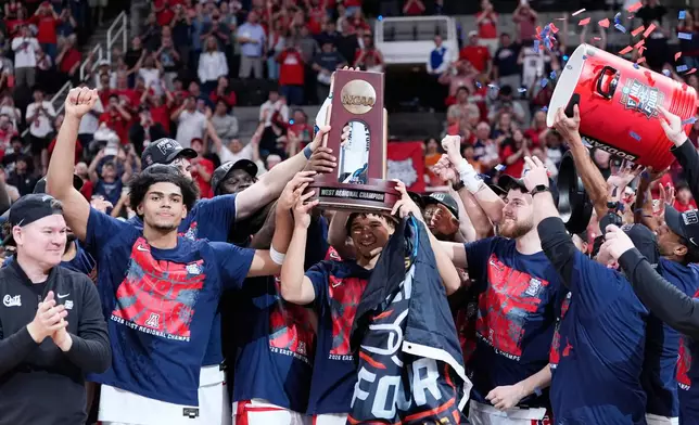 Arizona players hold a trophy after a win over Purdue in the Elite Eight of the NCAA college basketball tournament, Saturday, March 28, 2026, in San Jose, Calif. (AP Photo/Godofredo A. Vásquez)