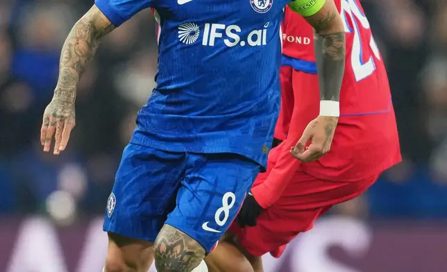 Chelsea's Enzo Fernandez, left, challenges for the ball with PSG's Bradley Barcola during the Champions League soccer match between Chelsea and Paris Saint-Germain in London, England, Tuesday, March 17, 2026. (AP Photo/Kin Cheung)