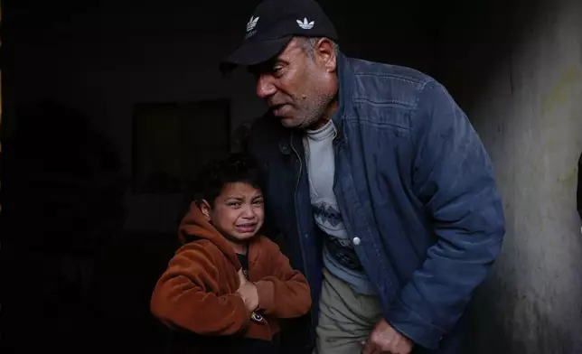 Yazid Al-Zayan, 9, mourns during the funeral for his father, Khaled Al-Zayan, a Palestinian policeman, who was killed in an Israeli military strike, in Khan Younis, southern Gaza Strip, Friday, Feb. 27, 2026. (AP Photo/Abdel Kareem Hana)