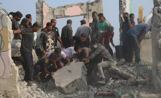 Rescue workers and residents search through the rubble in the aftermath of what Iranian officials said was an Israeli-U.S. strike on a girls' elementary school in Minab, Iran, Saturday, Feb. 28, 2026. (Abbas Zakeri/Mehr News Agency via AP)