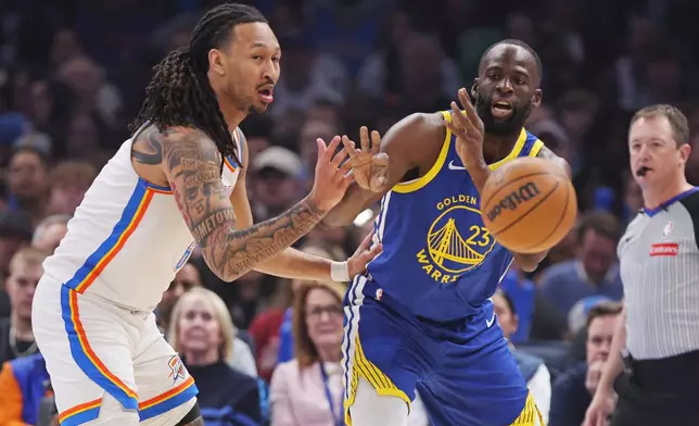 Golden State Warriors forward Draymond Green, right, passes the ball away from Oklahoma City Thunder forward Jaylin Williams, left, during the first half of an NBA basketball game Saturday, March 7, 2026, in Oklahoma City. (AP Photo/Nate Billings)