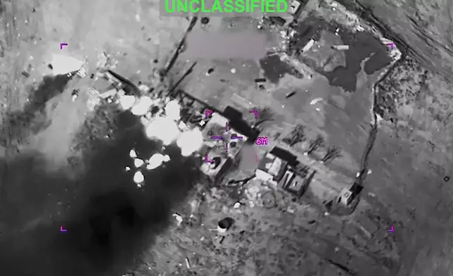 This partially redacted image from video provided by U.S. Central Command shows a complex of structures in Iran being struck by missiles fired by U.S. forces on Sunday, March 1, 2026. (U.S. Central Command via AP)