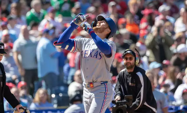 Texas Rangers' Brandon Nimmo celebrates his two run homer in the third inning of a baseball game against the Philadelphia Phillies, Sunday, March 29, 2026, in Philadelphia. (AP Photo/Laurence Kesterson)