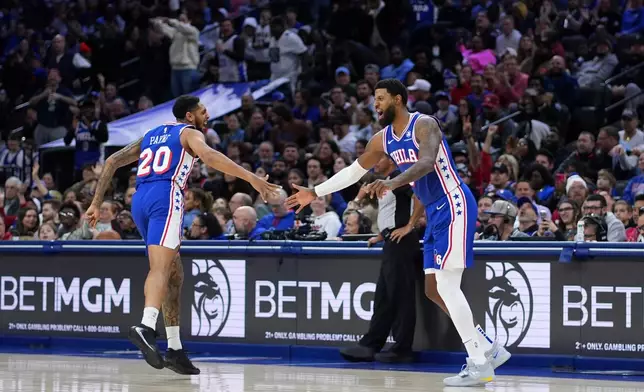 Philadelphia 76ers' Paul George, right, and Cameron Payne celebrate during the second half of an NBA basketball game against the Chicago Bulls Wednesday, March 25, 2026, in Philadelphia. (AP Photo/Matt Slocum)