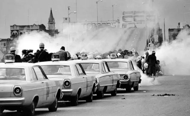 FILE - Tear gas fills the air as state troopers, ordered by Gov. George Wallace, break up a march at the Edmund Pettus Bridge in Selma, Ala., on Sunday, March 7, 1965. (AP Photo/File)