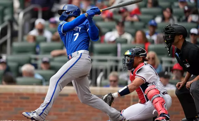 Kansas City Royals' Bobby Witt Jr. (7) hits an RBI-single in the third inning of a baseball game against the Atlanta Braves, Sunday, March 29, 2026, in Atlanta. (AP Photo/Mike Stewart)