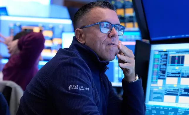 Traders work on the floor at the New York Stock Exchange in New York, Tuesday, March 10, 2026. (AP Photo/Seth Wenig)
