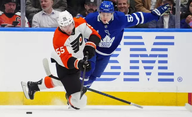 Toronto Maple Leafs' Easton Cowan (53) catches a penalty for tripping Philadelphia Flyers' Rasmus Ristolainen (55) during first-period NHL hockey game action in Toronto, Monday, March 2, 2026. (Frank Gunn/The Canadian Press via AP)