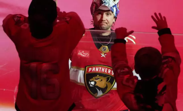 Florida Panthers goaltender Sergei Bobrovsky hands his stick to a fan after being named the second star of the game after an NHL hockey game against the Toronto Maple Leafs, Thursday, Feb. 26, 2026, in Sunrise, Fla. (AP Photo/Lynne Sladky)