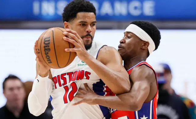 Detroit Pistons forward Tobias Harris (12) drives against Philadelphia 76ers guard Vj Edgecombe (77) during the first half of an NBA basketball game, Thursday, March 12, 2026, in Detroit. (AP Photo/Duane Burleson)