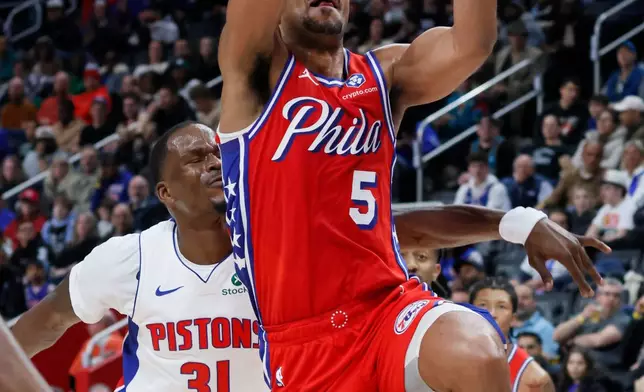 Philadelphia 76ers guard Quentin Grimes (5) goes to the basket past Detroit Pistons guard Javonte Green (31) during the first half of an NBA basketball game Thursday, March 12, 2026, in Detroit. (AP Photo/Duane Burleson)