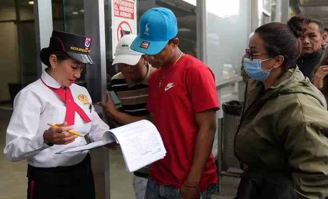 Yeferson de la Hoz, center, the cousin of soldier Mauro Penaranda who was on the cargo plane that crashed the previous day after take off in Puerto Leguizamo, arrives at the military hospital where he is being treated in Bogota, Colombia, Tuesday, March 24, 2026. (AP Photo/Fernando Vergara)