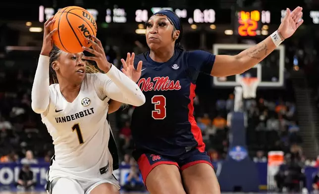 Vanderbilt guard Mikayla Blakes drives to the basket past Mississippi guard Kaitlin Peterson during second half of an NCAA college basketball game in the quarterfinals of the Southeastern Conference tournament, Friday, March 6, 2026, in Greenville, S.C. (AP Photo/Chris Carlson)