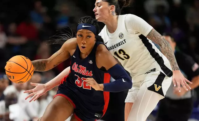 Ole Miss forward Cotie McMahon drives past Vanderbilt guard Justine Pissott during first half of an NCAA college basketball game in the quarterfinals of the Southeastern Conference tournament, Friday, March 6, 2026, in Greenville, S.C. (AP Photo/Chris Carlson)