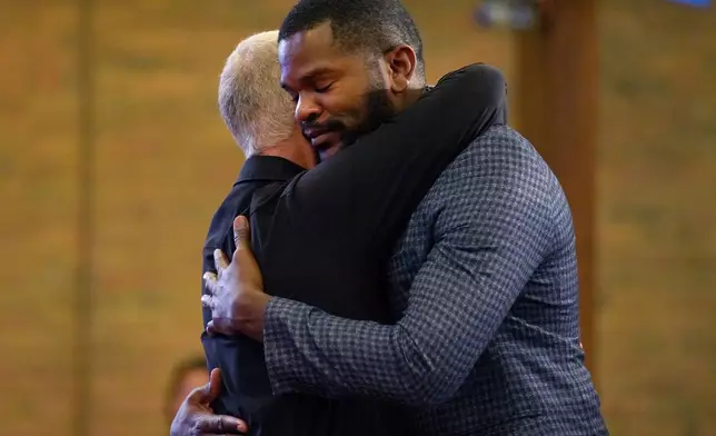 FILE - Carl Ruby, pastor at Central Christian Church, hugs Lindsay Aime during service, on Sept. 15, 2024, in Springfield, Ohio. (AP Photo/Jessie Wardarski)