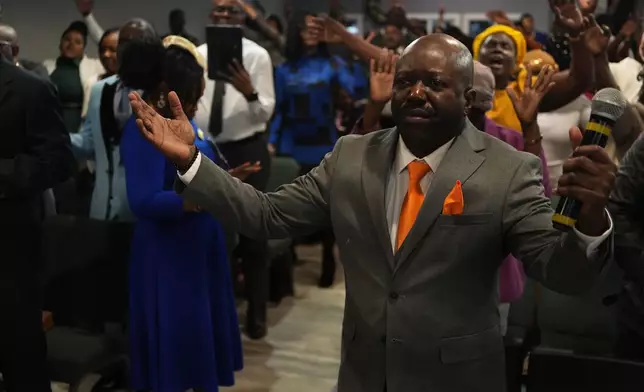 FILE - Rev. Reginald Silencieux, right, leads a worship service at the First Haitian Evangelical Church of Springfield, Feb. 1, 2026, in Springfield, Ohio. (AP Photo/Luis Andres Henao, file)