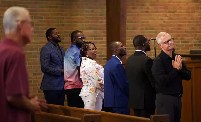 FILE - Members of the Haitian community, from left, Lindsay Aime, James Fleurijean, Rose-Thamar Joseph, Harold Herard, and Viles Dorsainvil, stand for worship with Carl Ruby, pastor at Central Christian Church, in Springfield, Ohio, on Sept. 15, 2024. (AP Photo/Jessie Wardarski, file)