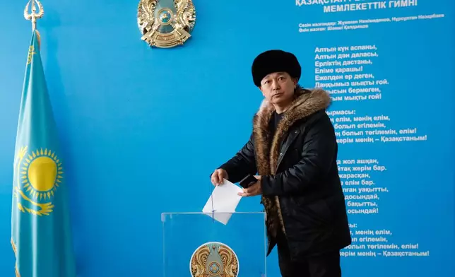 A man poses for a photo as he casts his ballot at a polling station during a referendum on a new constitution, in Astana, Kazakhstan, Sunday, on Sunday, March 15, 2026. (AP Photo)