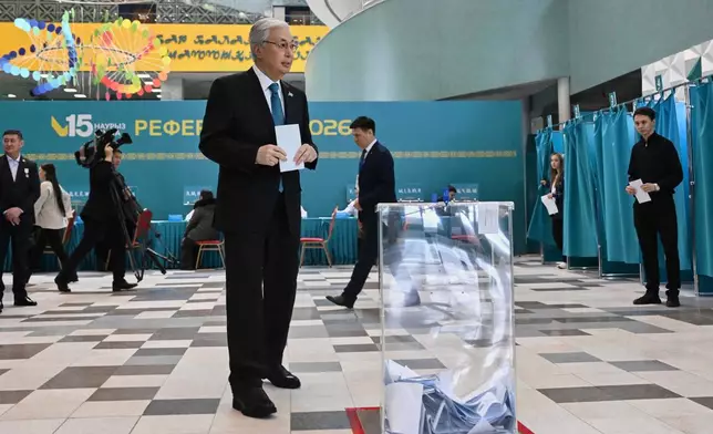 In this photo released by Kazakhstan's President Press Office, Kazakhstan's President Kassym-Jomart Tokayev walks to cast his ballot at a polling station during a referendum on a new constitution, in Astana, Kazakhstan, Sunday, March 15, 2026. (Kazakhstan's President Press Office via AP)
