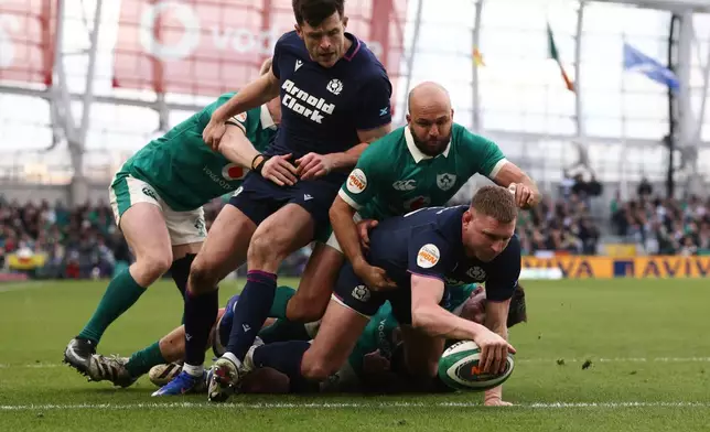 Scotland's Finn Russell, from, scores a try during the Six Nations rugby union match between Ireland and Scotland, in Dublin, Saturday, March 14, 2026. (AP Photo/Peter Morrison)