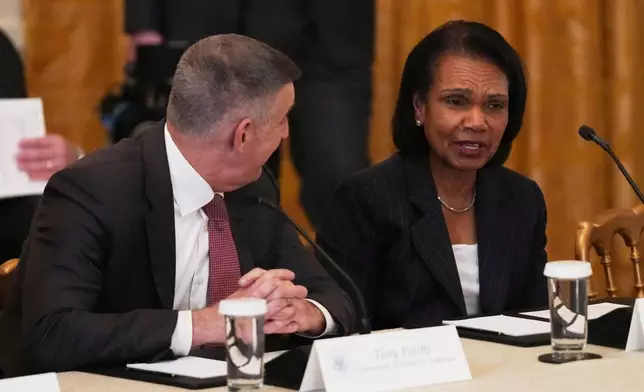 Big Ten Conference commissioner Tony Petitti, left, talks with former U.S. Secretary of State Condoleezza Rice before a roundtable discussion about college sports in the East Room of the White House, Friday, March 6, 2026, in Washington. (AP Photo/Julia Demaree Nikhinson)