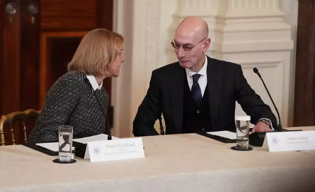 Chief Executive Officer of U.S. Olympic &amp; Paralympic Committee Sarah Hirshland speaks with NBA commissioner Adam Silver before a roundtable discussion on college sports in the East Room of the White House, Friday, March 6, 2026, in Washington. (AP Photo/Julia Demaree Nikhinson)