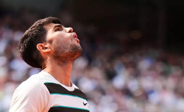 FILE - Spain's Carlos Alcaraz reacts during the final of the French Open tennis tournament against Italy's Jannik Sinner, Sunday, June 8, 2025, in Paris. (AP Photo/Lindsey Wasson, File)
