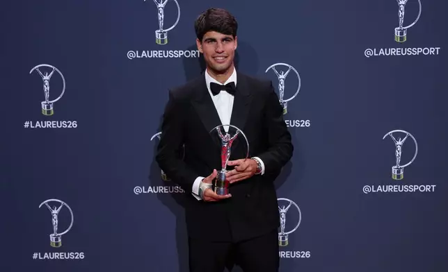 Carlos Alcaraz poses with his Laureus World Sportsman of the Year award during the 2026 Laureus World Sports Awards ceremony in Madrid, Spain, Monday, April 20, 2026. (AP Photo/Manu Fernandez)