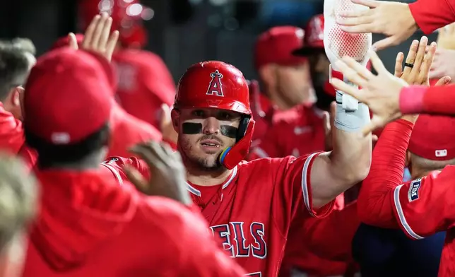 Los Angeles Angels' Mike Trout celebrates with teammates after scoring on a sacrifice fly by Jorge Soler during the first inning of a baseball game against the Chicago White Sox in Chicago, Monday, April 27, 2026. (AP Photo/Nam Y. Huh)