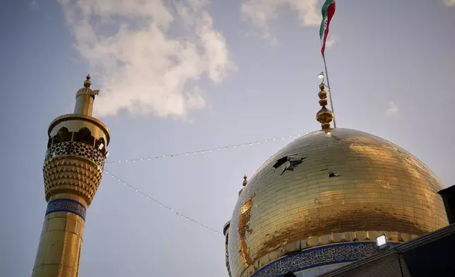 A hole is seen in the dome of the Grand Hosseiniyeh mosque that officials say was hit by U.S.-Israeli airstrikes Tuesday in Zanjan, Iran, Saturday, April 4, 2026. (AP Photo/Francisco Seco)