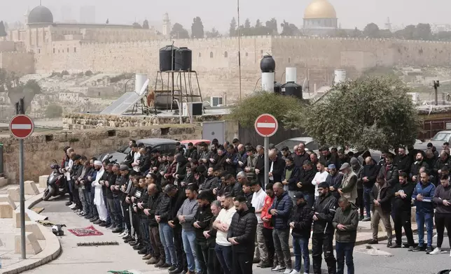 Palestinian Muslims attend Friday prayers outside Jerusalem's Old City due to restrictions linked to the Iran war, April 3, 2026. (AP Photo/Mahmoud Illean)