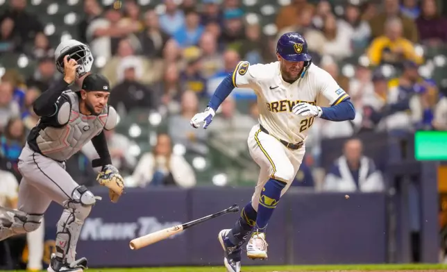 Milwaukee Brewers' Brandon Lockridge (20) bunts a single against Arizona Diamondbacks catcher Adrian del Castillo during the third inning of a baseball game Wednesday, April 29, 2026, in Milwaukee. (AP Photo/Andy Manis)